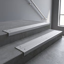 Aluminium stair nosing 90x32mm double channel fitted to a concrete step - Mill Aluminium finish with twin Mill Aluminium inserts