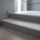 Aluminium stair nosing 90x32mm double channel fitted to a concrete step - Mill Aluminium finish with twin Polar Grey Castellated inserts