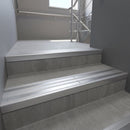 Aluminium stair nosing 90x32mm double channel fitted to a concrete step - Mill Aluminium finish with twin Polished Aluminium inserts