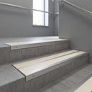 Aluminium stair nosing 90x32mm double channel fitted to a concrete step - Mill Aluminium finish with twin Porth Stone Smooth Textured inserts