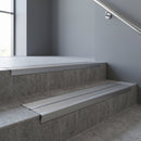 Aluminium stair nosing 90x32mm double channel fitted to a concrete step - Mill Aluminium finish with twin Satin Aluminium inserts