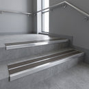 Aluminium stair nosing 90x32mm double channel fitted to a concrete step - Polished Aluminium finish with twin Granite Castellated inserts