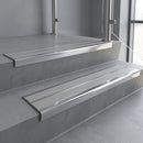 Aluminium stair nosing 90x32mm double channel fitted to a concrete step - Polished Aluminium finish with twin Light Grey Smooth Textured inserts