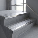 Aluminium stair nosing 90x32mm double channel fitted to a concrete step - Polished Aluminium finish with twin Mill Aluminium inserts
