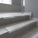 Aluminium stair nosing 90x32mm double channel fitted to a concrete step - Polished Aluminium finish with twin Polar Grey Smooth Textured inserts