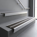 Aluminium stair nosing 90x32mm double channel fitted to a concrete step - Satin Aluminium finish with twin Granite Castellated inserts