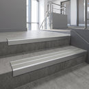 Aluminium stair nosing 90x32mm double channel fitted to a concrete step - Satin Aluminium finish with twin Mill Aluminium inserts