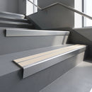 Aluminium stair nosing 90x32mm double channel fitted to a concrete step - Satin Aluminium finish with twin Porth Stone Smooth Textured inserts