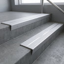 Aluminium stair nosing 90x32mm double channel fitted to a concrete step - Satin Aluminium finish with twin Satin Aluminium inserts