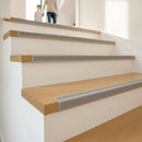 Heavy-duty aluminium stair nosing Jumbo 35mm installed on oak staircase UK family home parent and child