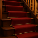 Bronze stair rods installed on traditional British staircase with red carpet runner