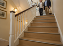 Oak wood-effect laminate stair nosing installed on traditional UK staircase - matching oak laminate finish