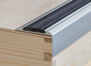 Close-up of anodised aluminium stair nosing showing rubber anti-slip insert and hidden screw-fix installation