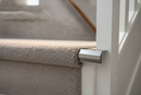 Inox brushed aluminium stair nosing end cap fitted to a carpeted staircase edge in a UK home hallway