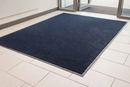 Blue mix heavy duty entrance barrier mat laid at a school corridor entrance on light tile flooring