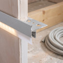 Cut end of the Genesis NLD tile-in LED nosing showing the perforated flange, down-leg and frosted diffuser