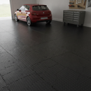 Home garage floor fully tiled in black diamond-plate PVC interlocking tiles with a car and tool cabinet