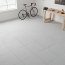Home workshop floor fully tiled in light grey diamond-plate PVC interlocking tiles with a bicycle and workbench