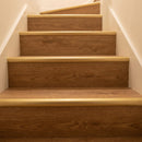Gold anodised LVT stair nosing 42x28mm fitted on warm oak vinyl stairs