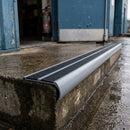 Bullnose aluminium stair nosing 98x40mm with twin Black / Black gritted GRP inserts, fitted to a concrete step at a loading bay doorway on a distribution unit