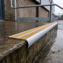 Bullnose aluminium stair nosing 98x40mm with twin Yellow / Yellow gritted GRP inserts, fitted to a concrete step on an external service stair at an industrial unit