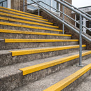 Yellow GRP anti-slip stair nosing fitted full width across every tread of UK school entrance steps