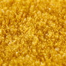 Close-up of the coarse external grade anti-slip grit on a yellow GRP stair nosing