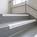 White GRP stair nosings on concrete steps in a school or hospital stairwell