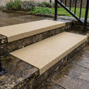 Buff stone coloured GRP stair tread cover fitted over weathered external stone steps