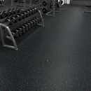 Commercial gym free weights area floor covered in black rubber flooring with blue flecks and a dumbbell rack