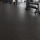 CrossFit style training box floor covered in black rubber flooring with red flecks and a kettlebell rack