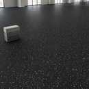 Boutique fitness studio stretching zone floor covered in black rubber flooring with white flecks