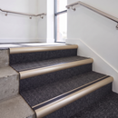 Aluminium Stair Nosing 2.75m Bullnose Single Insert 57mm in Satin Bronze finish fitted on a commercial stair