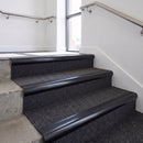 Heavy duty bullnose aluminium stair nosing with black insert in satin black finish fitted on an office stairwell with charcoal contract carpet