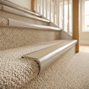 Beige insert carpet stair nosings fitted to a cream carpeted domestic staircase