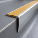 Close-up of the chevron stair nosing end showing the flush insert and angled riser face