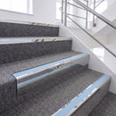 Mirrorflect silver chevron stair nosing with pale blue Aura insert fitted on carpeted stairs