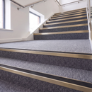 Rake Back Stair Nosing 2.44m Aluminium 62mm Single Insert in Satin Bronze finish fitted on a commercial stair