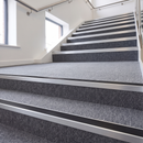 Rake Back Stair Nosing 2.44m Aluminium 62mm Single Insert in Satin Silver finish fitted on a commercial stair