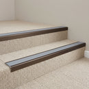 Dark bronze aluminium stair nosing with Mid Grey insert fitted to pale sand carpet tile on a building society stair