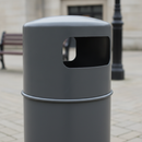 Close-up of the dark grey hooded top litter bin showing the smooth domed lift-off hood, the rounded rectangular side aperture and the horizontal joint where the hood seats on the cylindrical body
