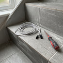 2m LED extension lead coiled on a freshly tiled grey stair tread beside a screwdriver