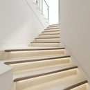 Titanium finish aluminium LED stair nosing profiles with LED step lighting on a modern staircase
