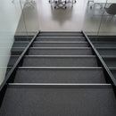 Heavy duty aluminium stair nosing with black anti-slip PVC insert fitted on commercial office staircase UK