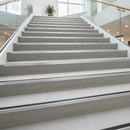 Heavy duty aluminium stair nosing with white anti-slip PVC insert on hotel staircase UK