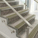 Light bronze raked back nosings with matching ribbed inserts on mottled stone steps