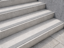 Mid-grey inserts blending into pale concrete steps, seen from the side at close range
