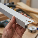 Hand holding an aluminium LED stair nosing profile showing its L-shape and fixing holes