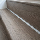 Silver anodised aluminium inner corner profile fitted in the angle where an LVT stair tread meets the riser above it