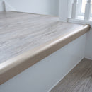 Champagne anodised aluminium 42x28mm stair nosing with rounded nose fitted flush on a whitewashed oak click vinyl tread, 28mm face on the white riser